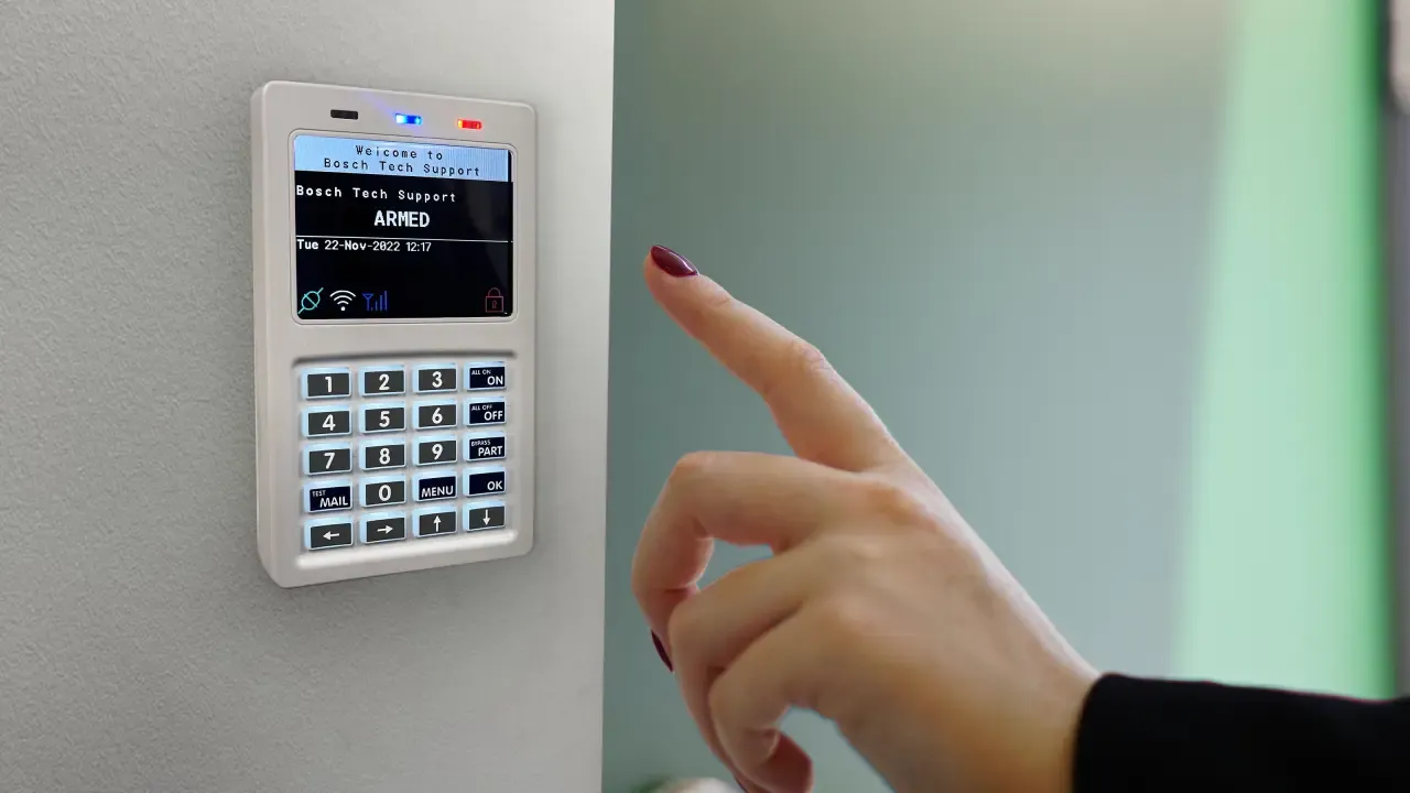 a finger pointing at a keypad